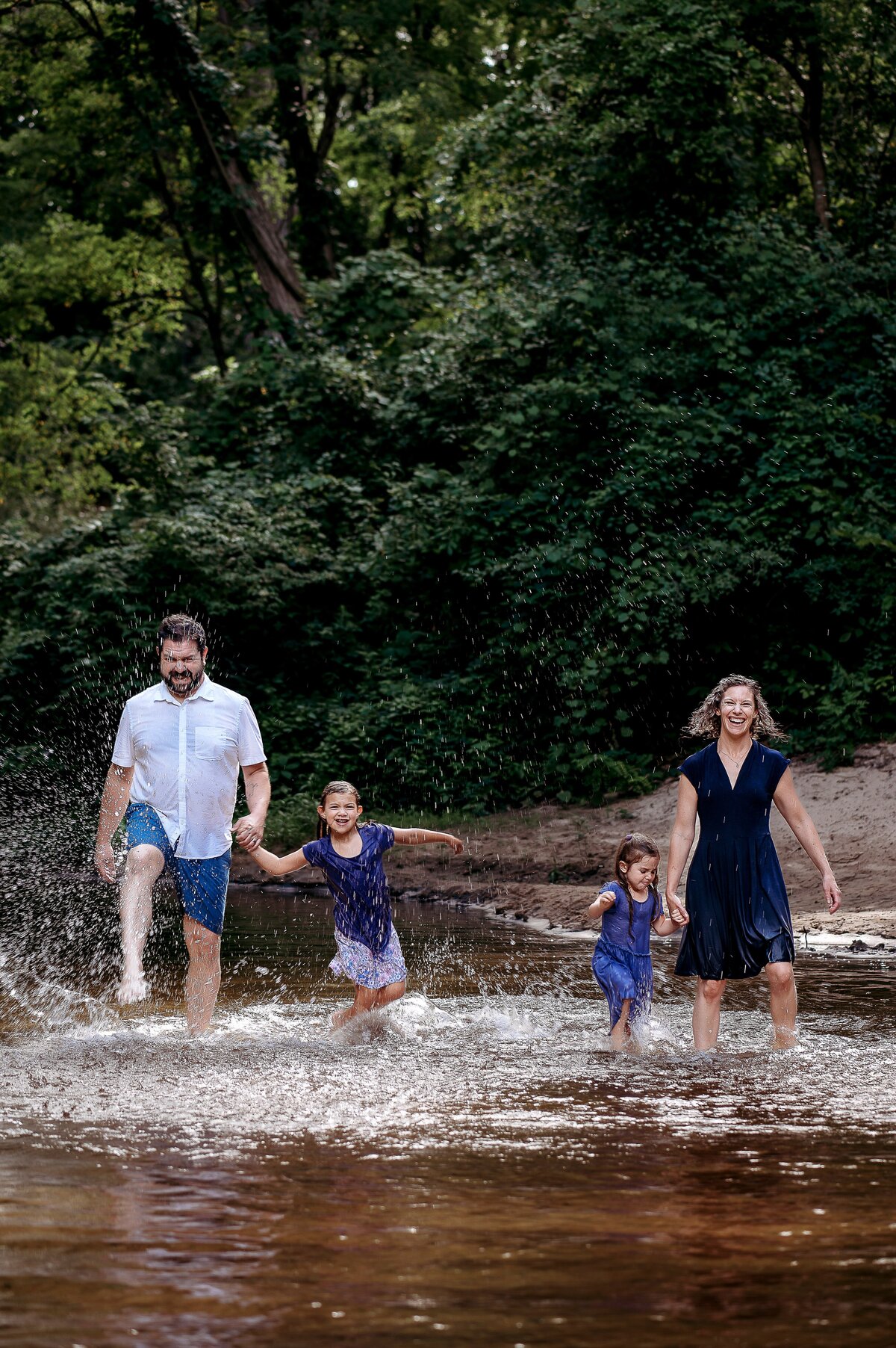 Family playing in creek McKennaPattersonPhotography