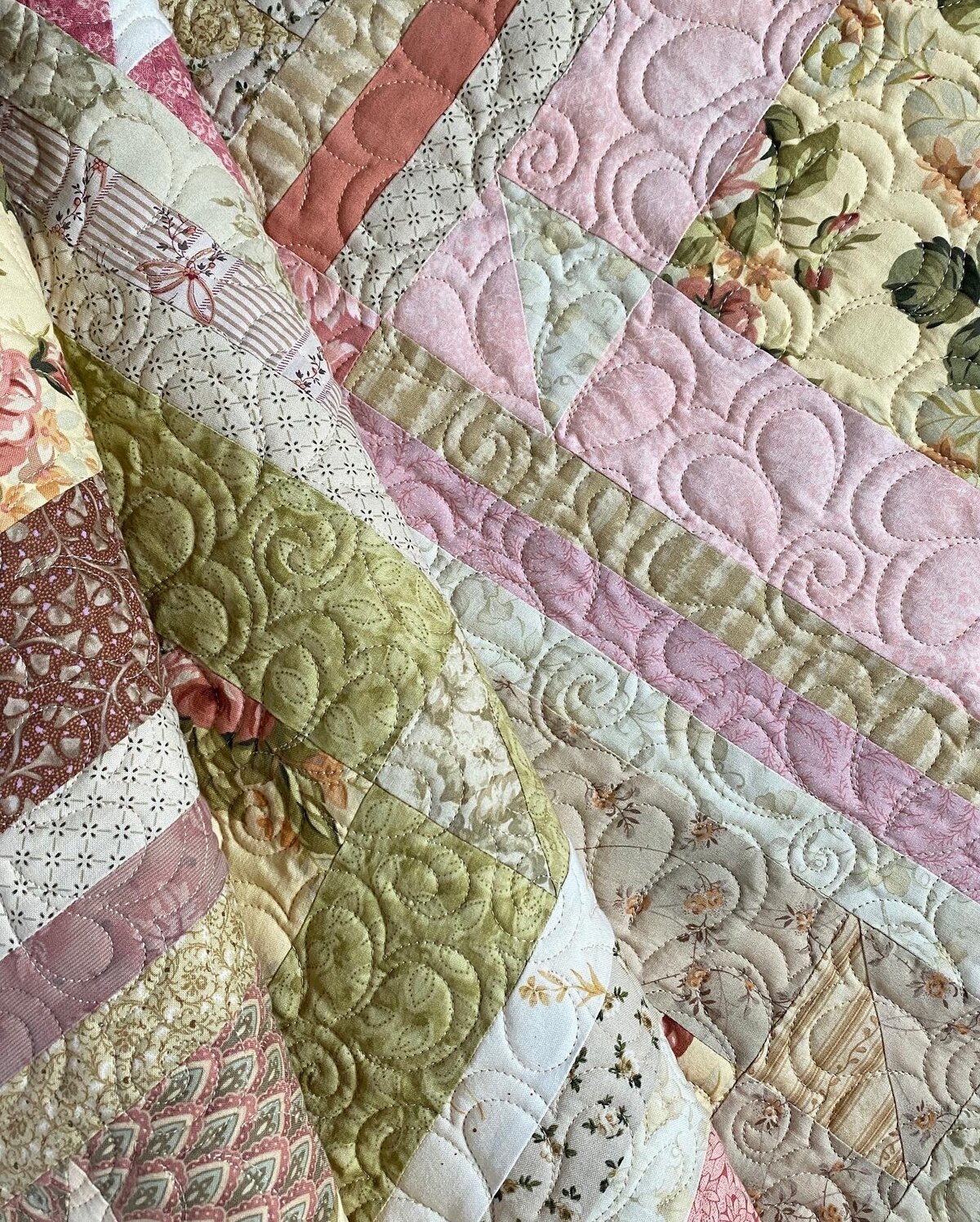 Hibiscus quilting design featured on a pink and green quilt.