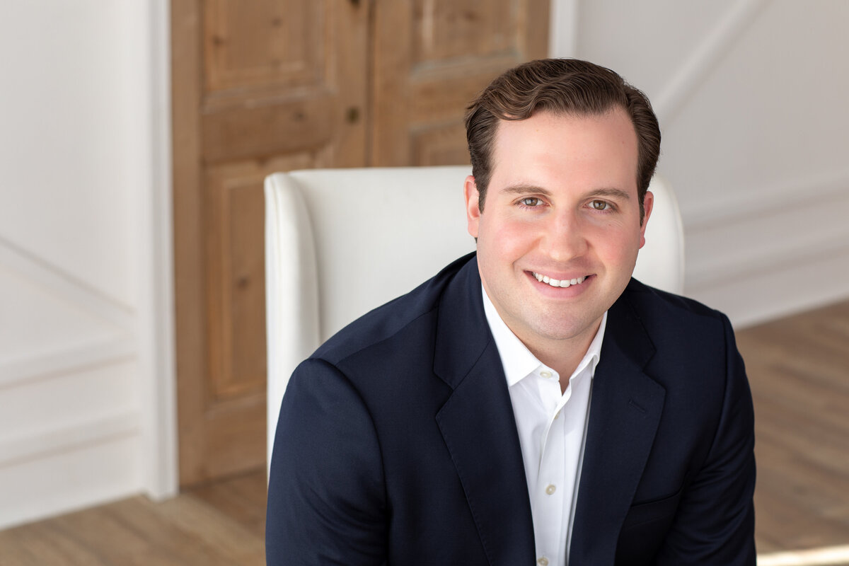 Man in a suit leaning slightly forward for a more relaxed professional portrait