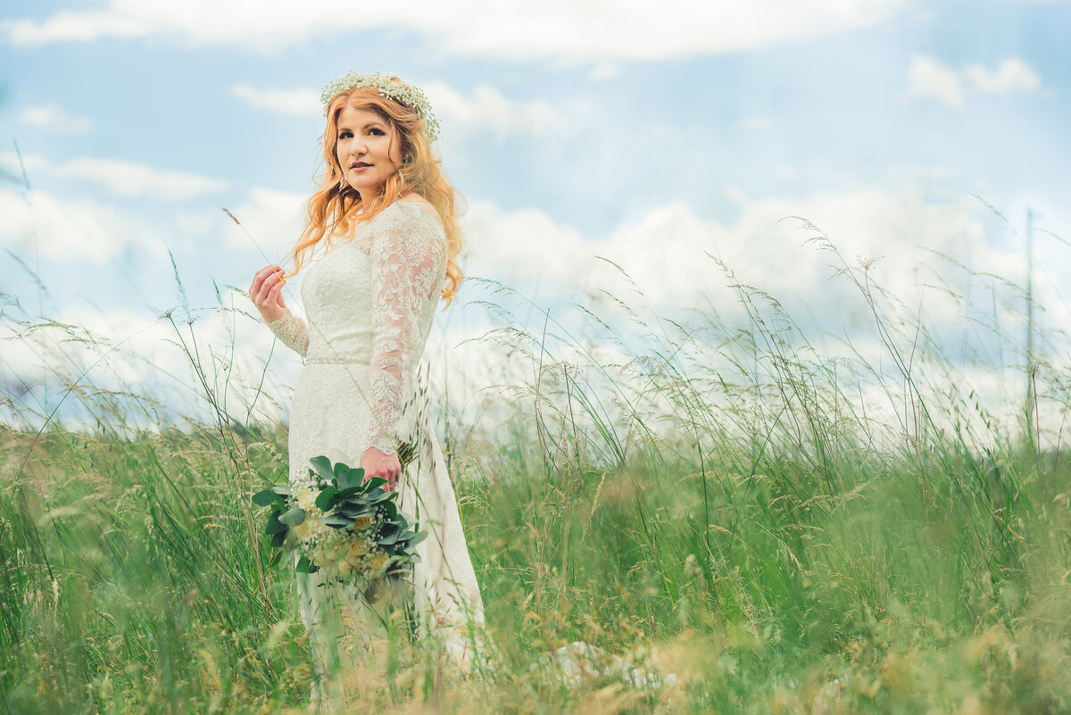 bride in field on sunny day