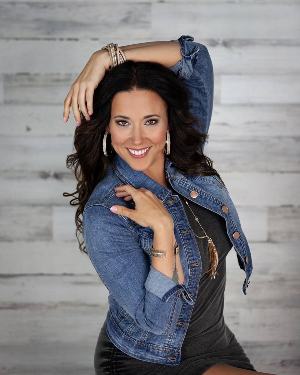 Woman arms posed wearing jean jacket in Austin beauty photoshoot