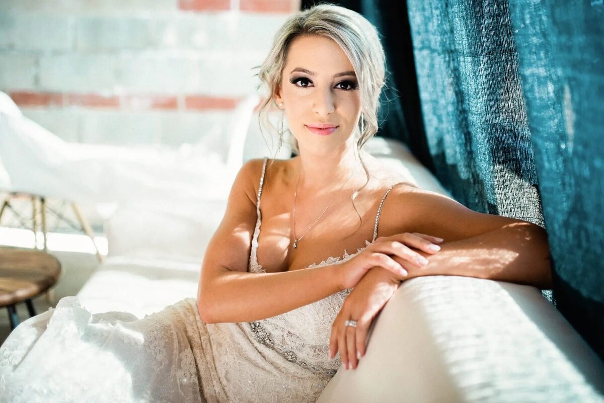 A bride resting along the back of a couch.