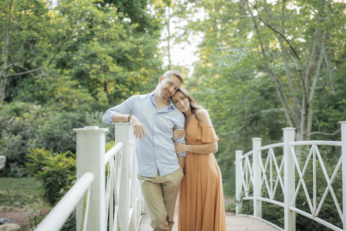 Couple during session by white bridge at Sayen House and Gardens in Hamilton Township Mercer County New Jersey