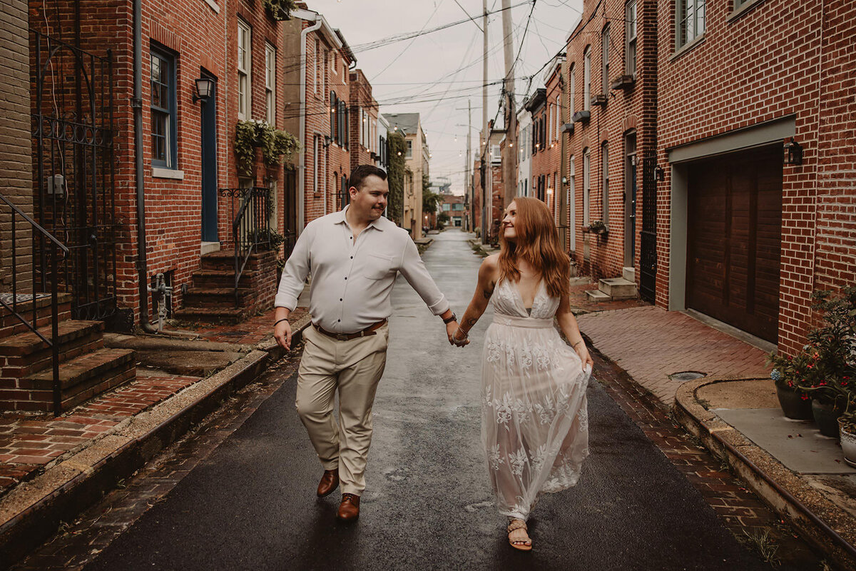 A couple holding hands and walking down an aisle 