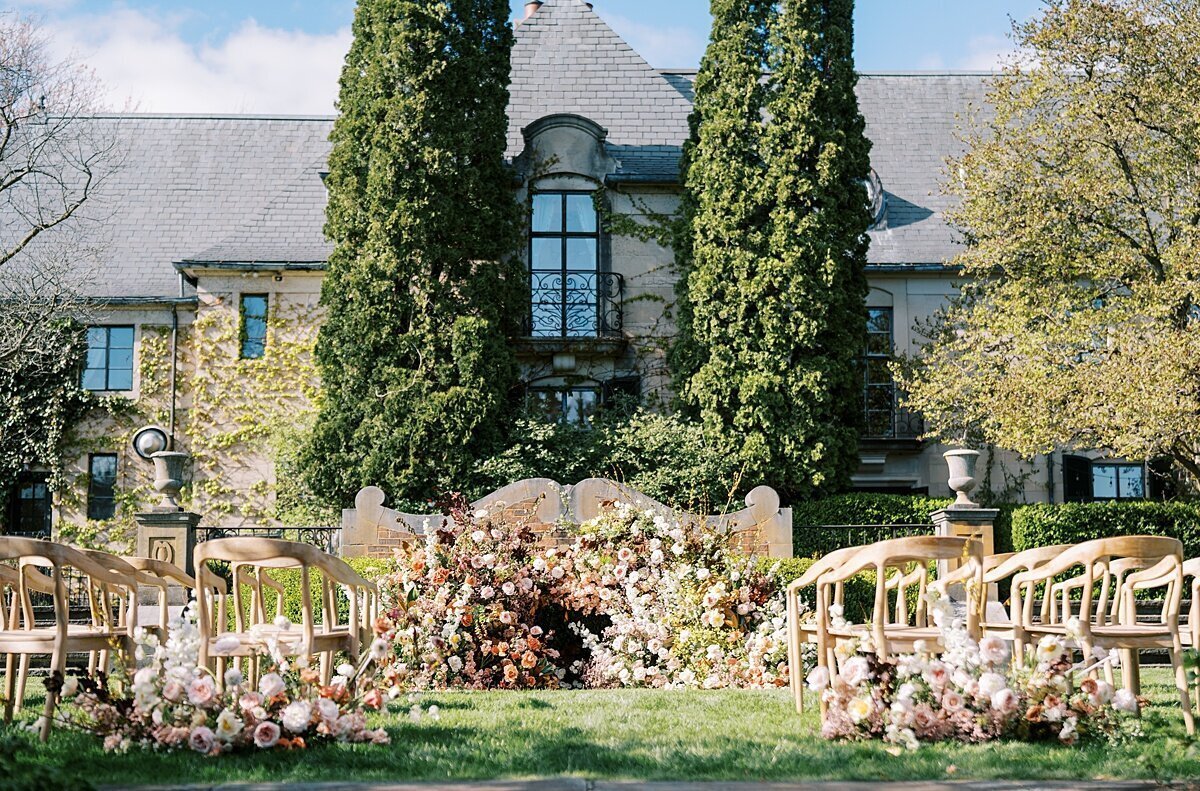 Bride and groom in front of a foral arched catholic church, chicago wedding photos by Allison Francois Photography