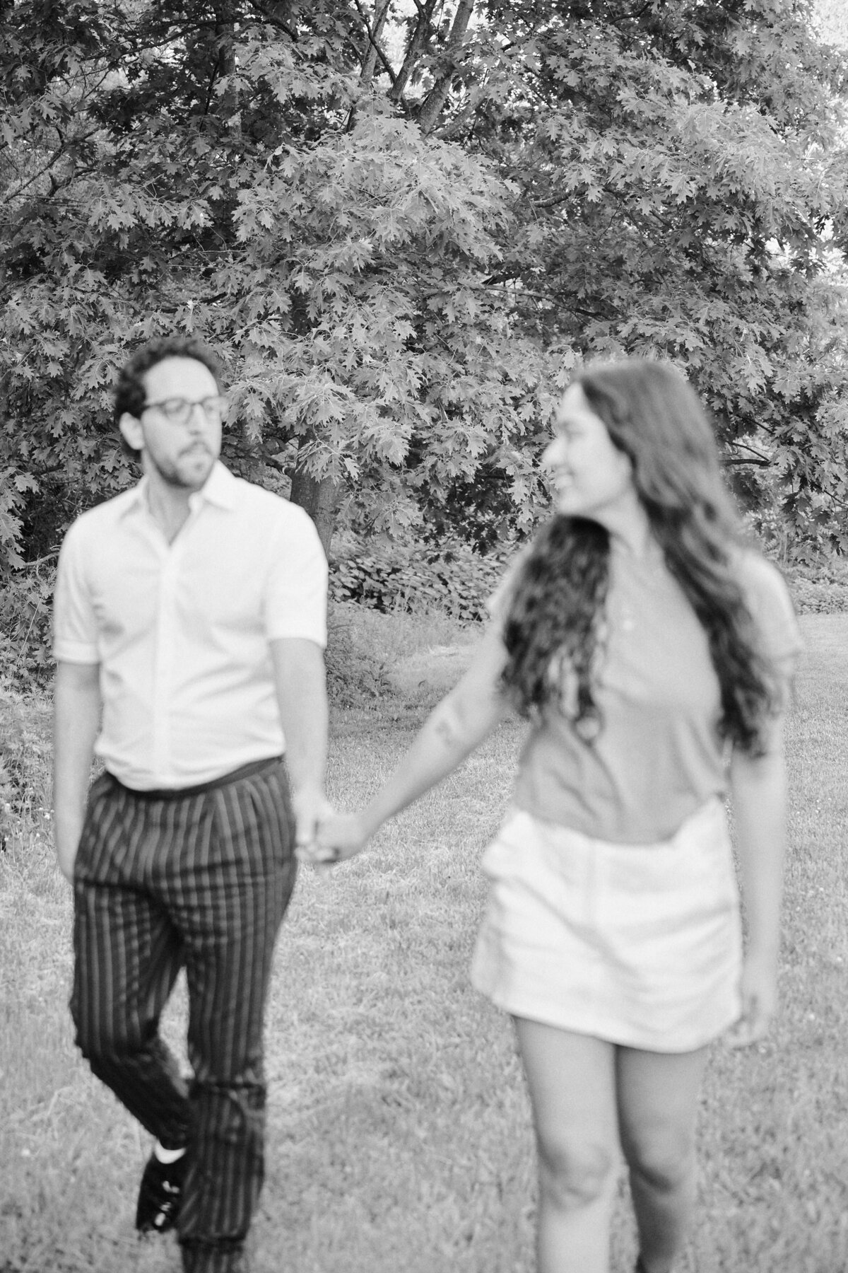 Couple walks together  after a successful New York City Picnic Proposal, photo taken by New York City Proposal Photographer, Corey Lamar Photography.  Photo is blurred for a artistic effect