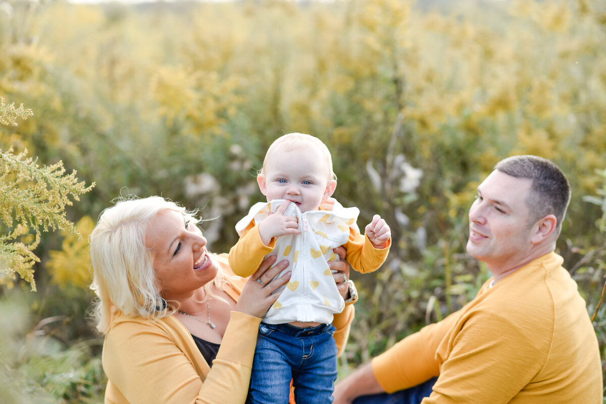 Family dressed in matching yellow outfits for outdoor portraits photo by Michelle Lynn Photography located near Louisville, Kentucky