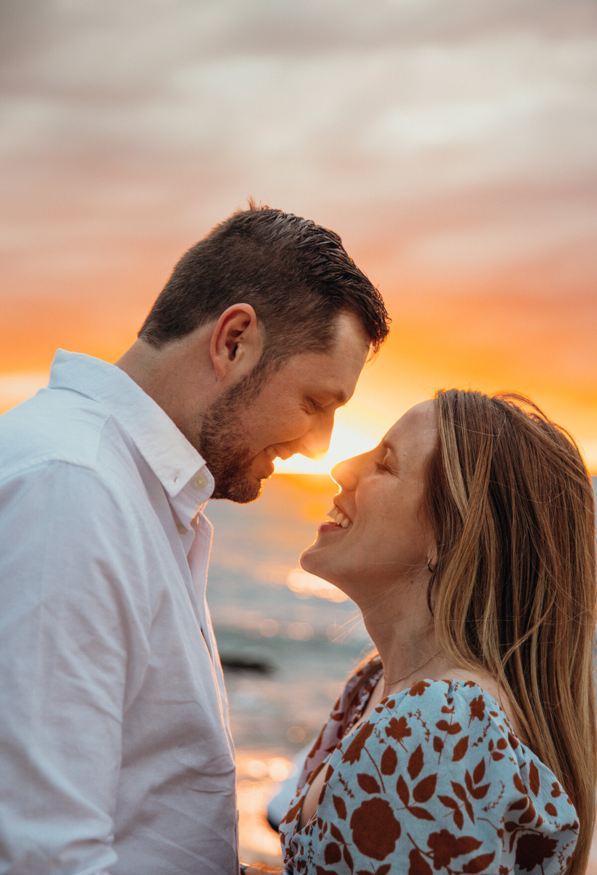 Hawaii Engagement Photographer captures couple laughing at sunset