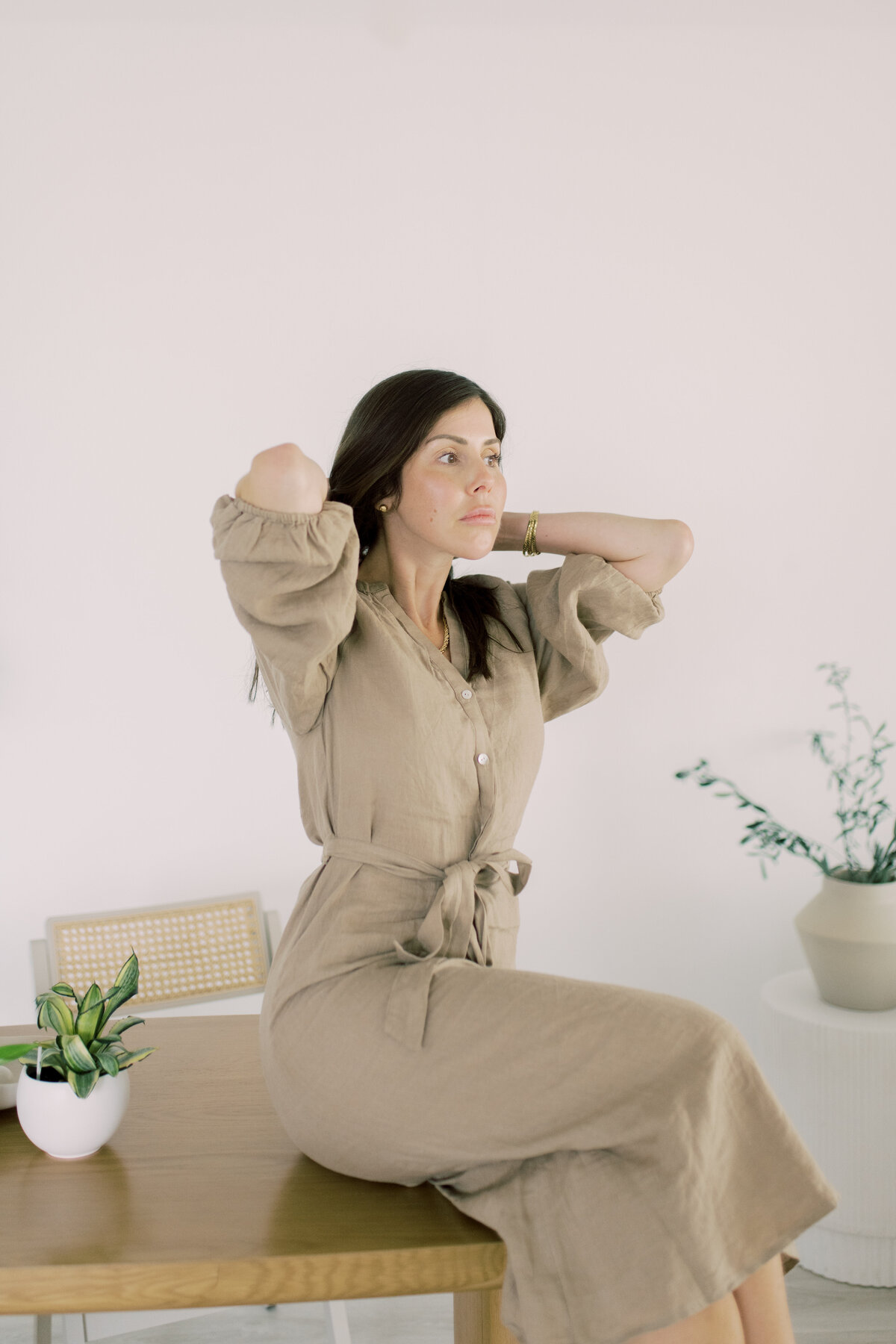 In Linen and girl fixing hair looking elegant