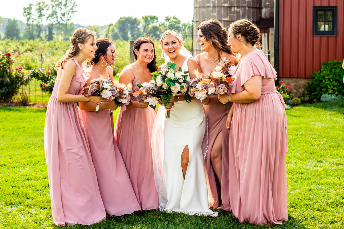 Bride and bridesmaids photo at an outside barn wedding. Photo by Devin Ramon Photography.