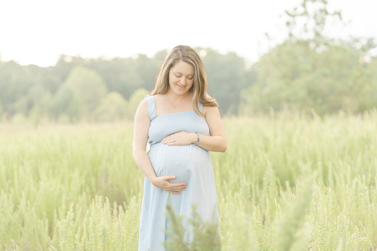 mom looking down on her belly taken by TBP, a Sterling, Virginia maternity photographer