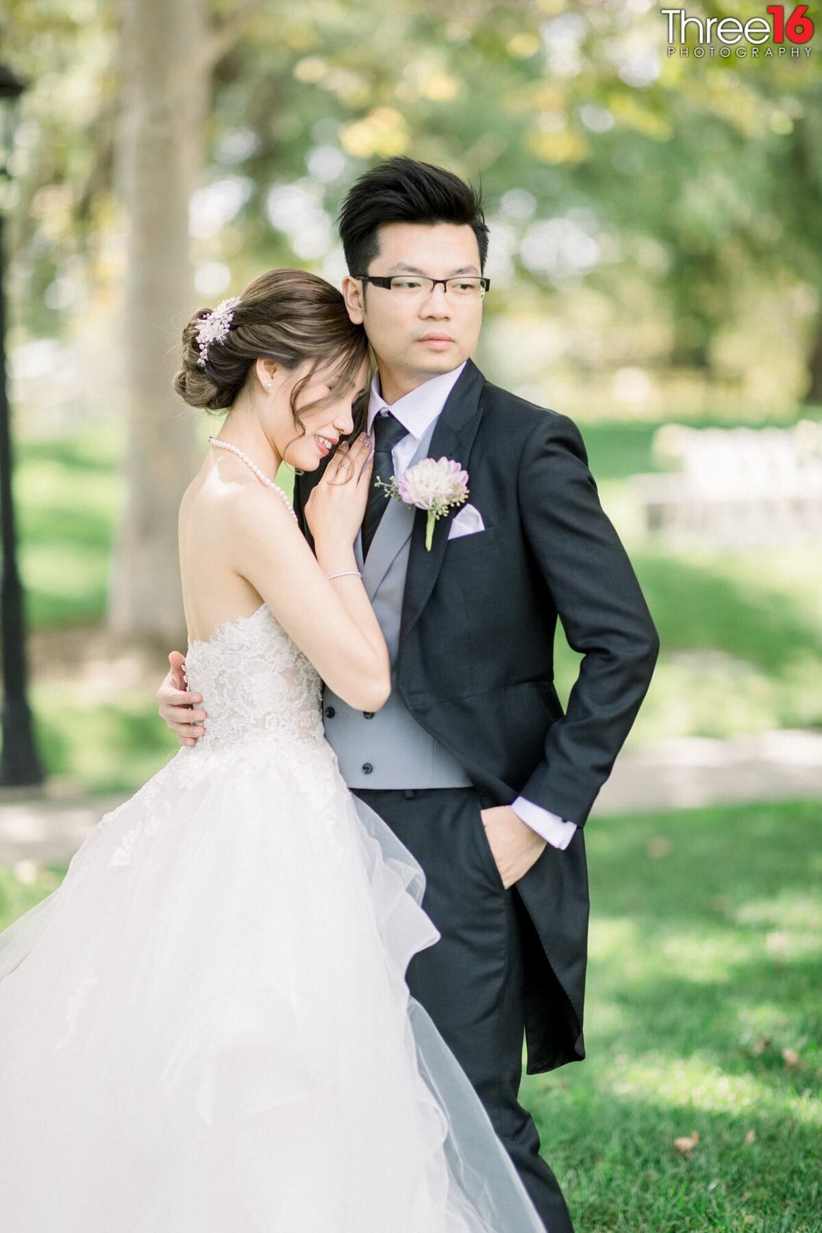 Bride rests her head on her Groom's chest during photo session