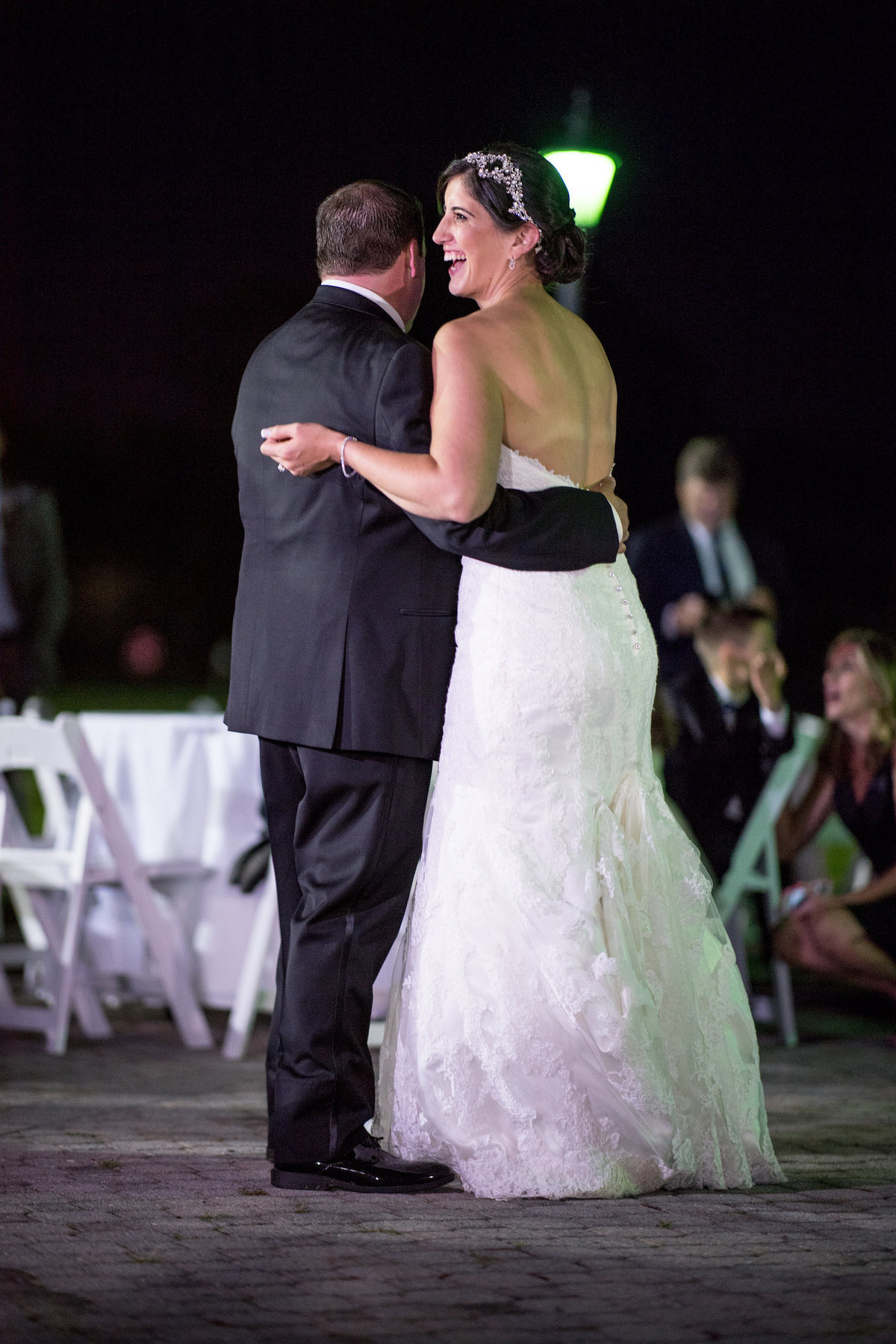 photo of bride smiling and dancing with her groom during wedding reception at Lawrence Yacht and Country Club