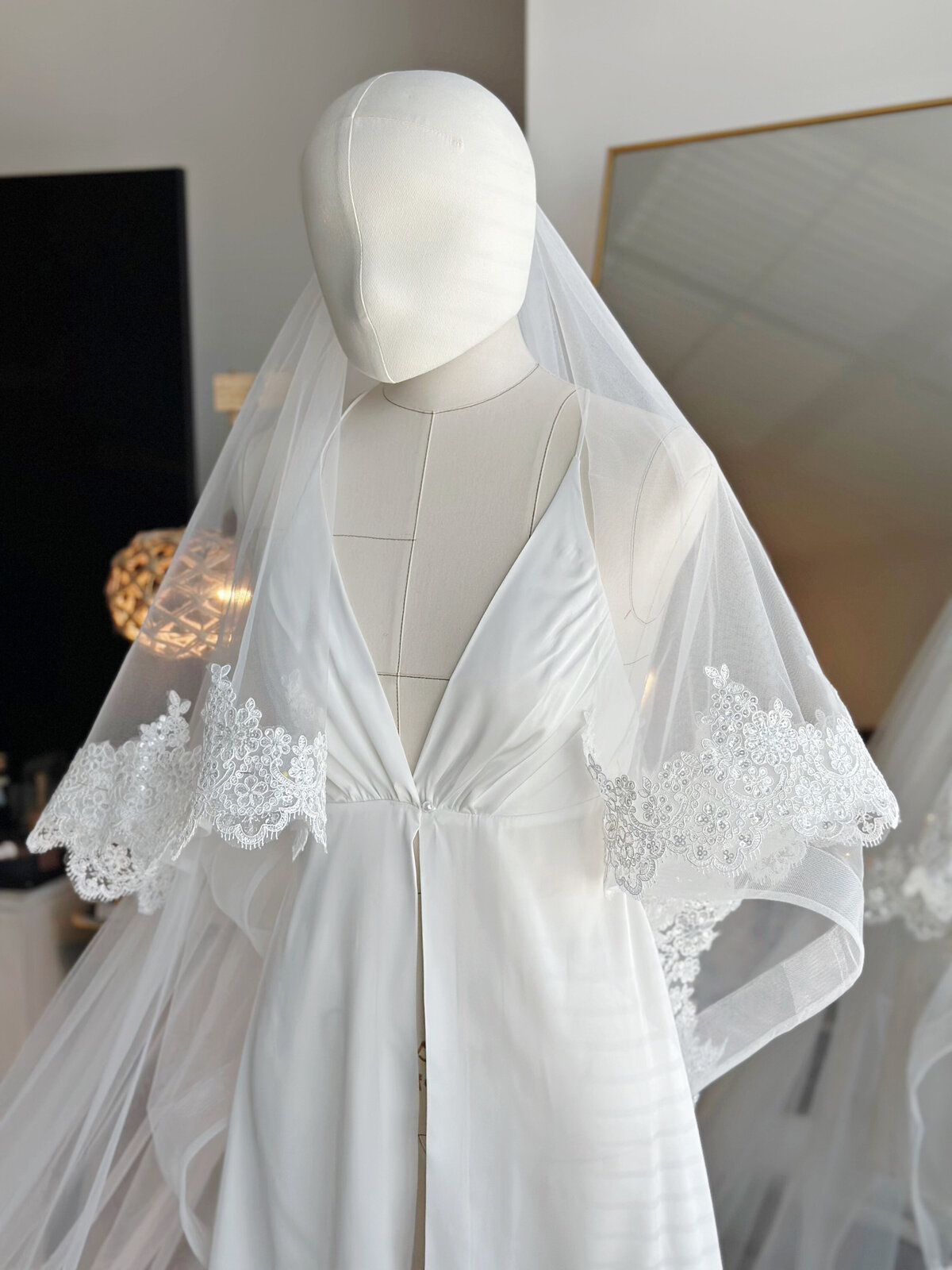 Close-up of lace trim and pearl accents on blusher veil
