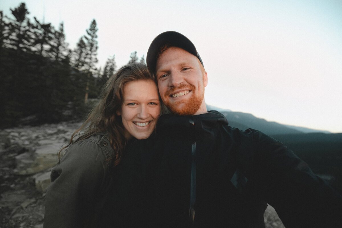 Wedding Photographer Connor Esau and his partner Allison on a mountain smiling