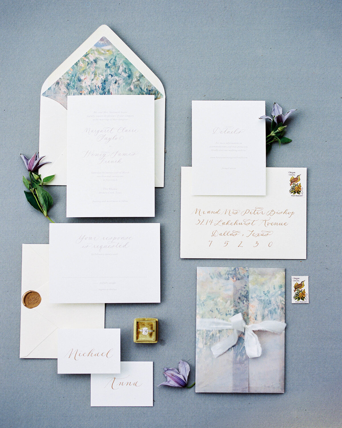 A classic blue flatlay image of a custom invitation suite for a wedding.