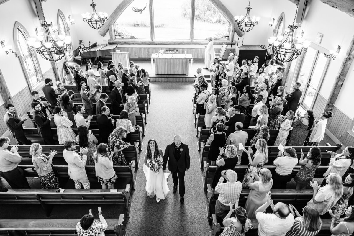 Bride and groom ceremony exit at Big Sky Chapel in Big Sky, MT