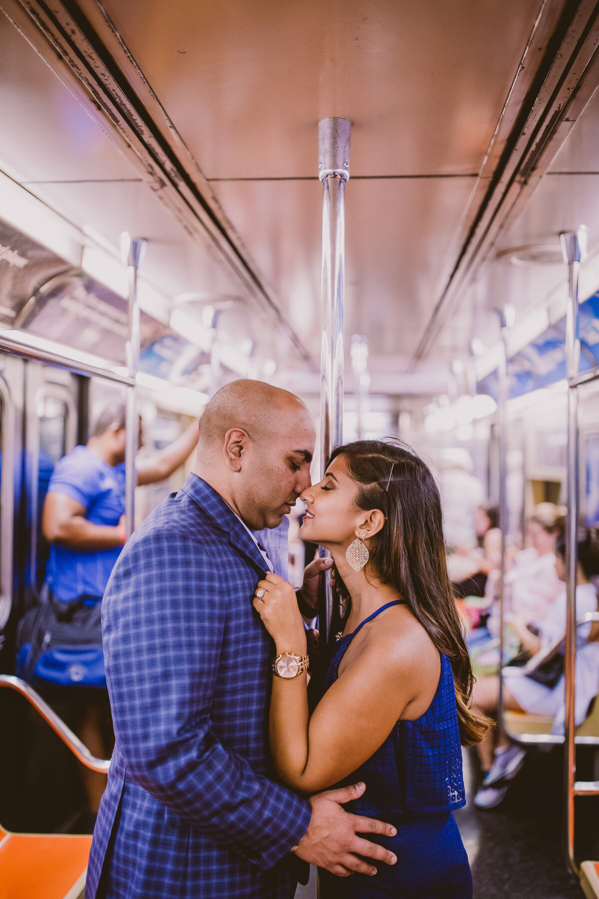 An engaged couple share a moment in the nyc subway train during their engagement session