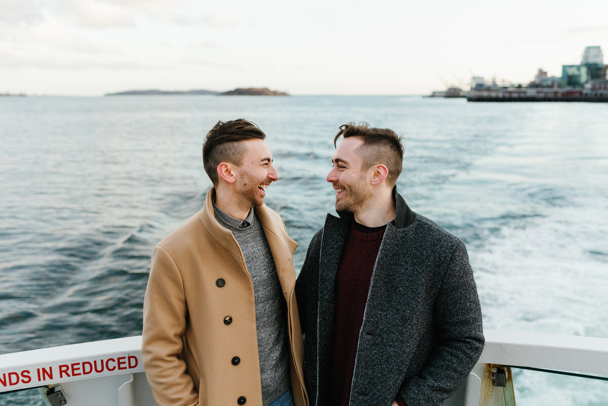 Cute couple gazing into each other's eyes on a boat in Halifax, Nova Scotia.