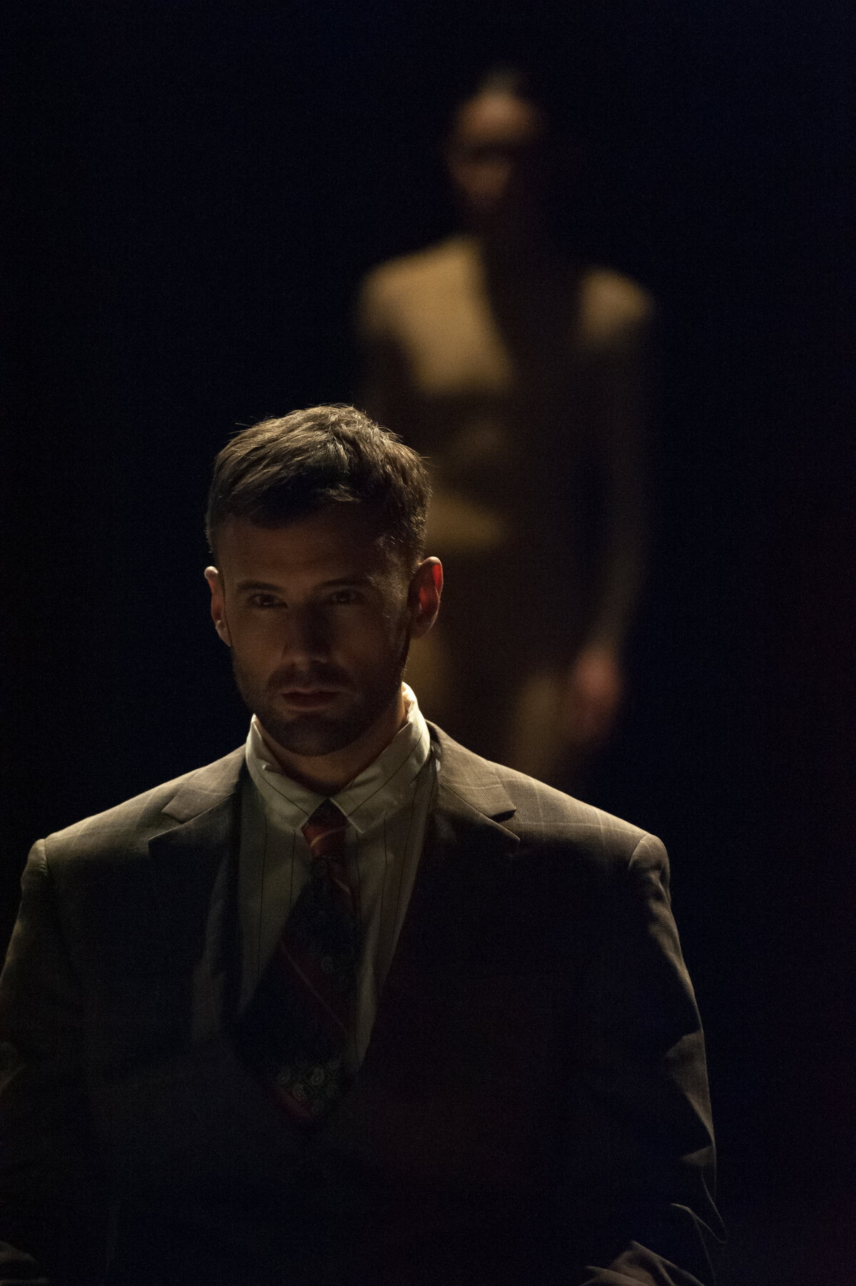 Man in Suit on stage