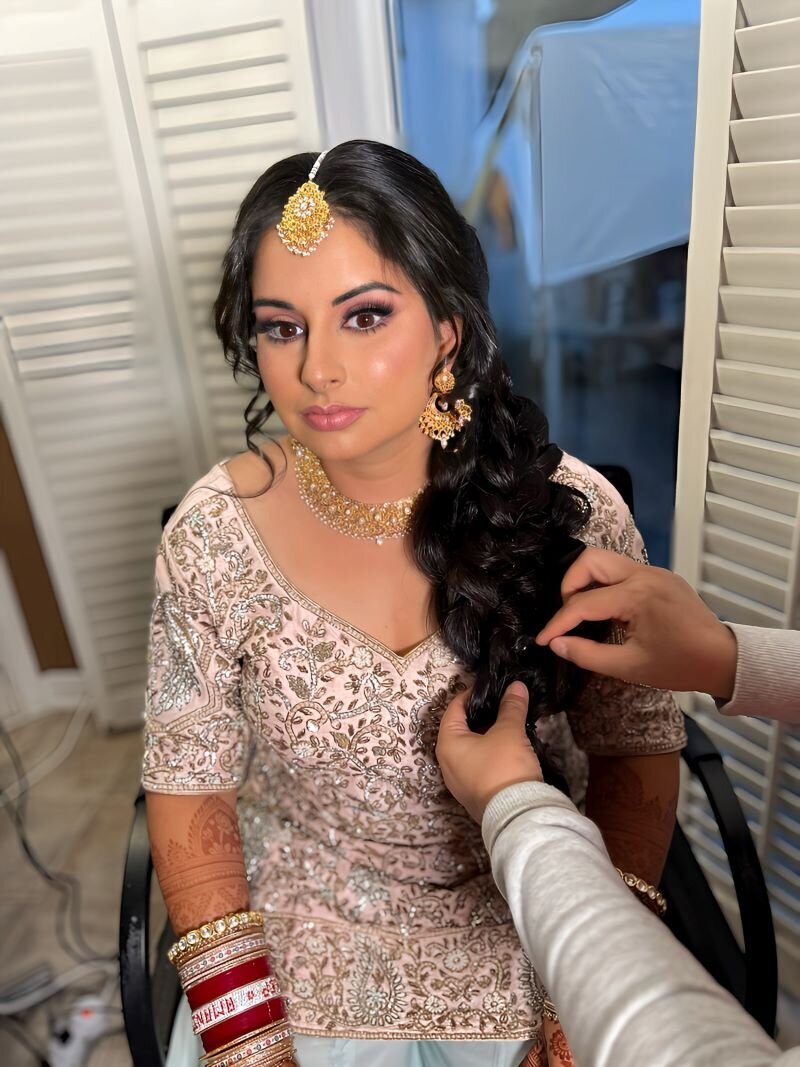Indian bride in Ottawa adorned with a classic makeup look, including flawless skin and a pink lip for subtle beauty.