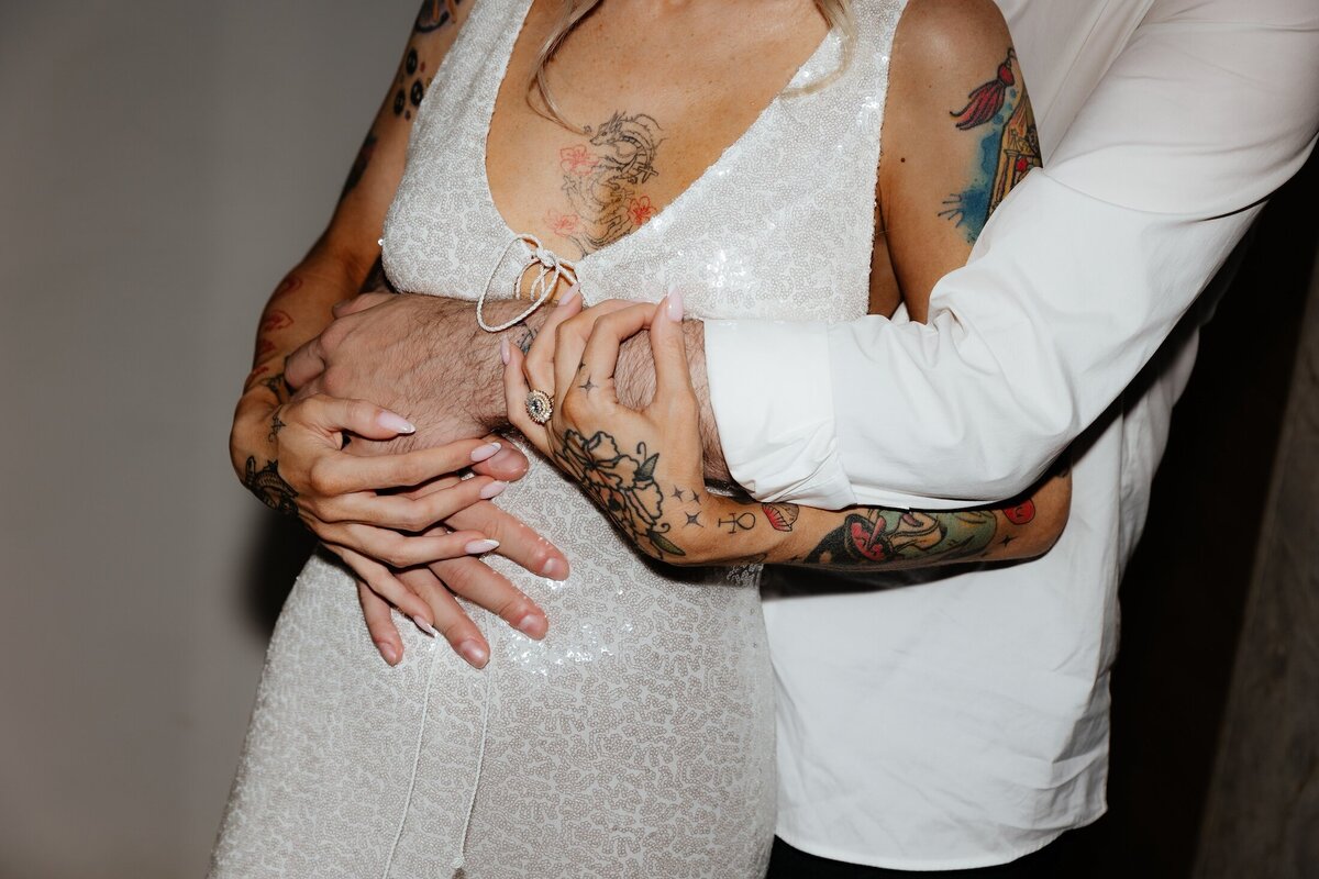 detail shot of bride and groom hugging