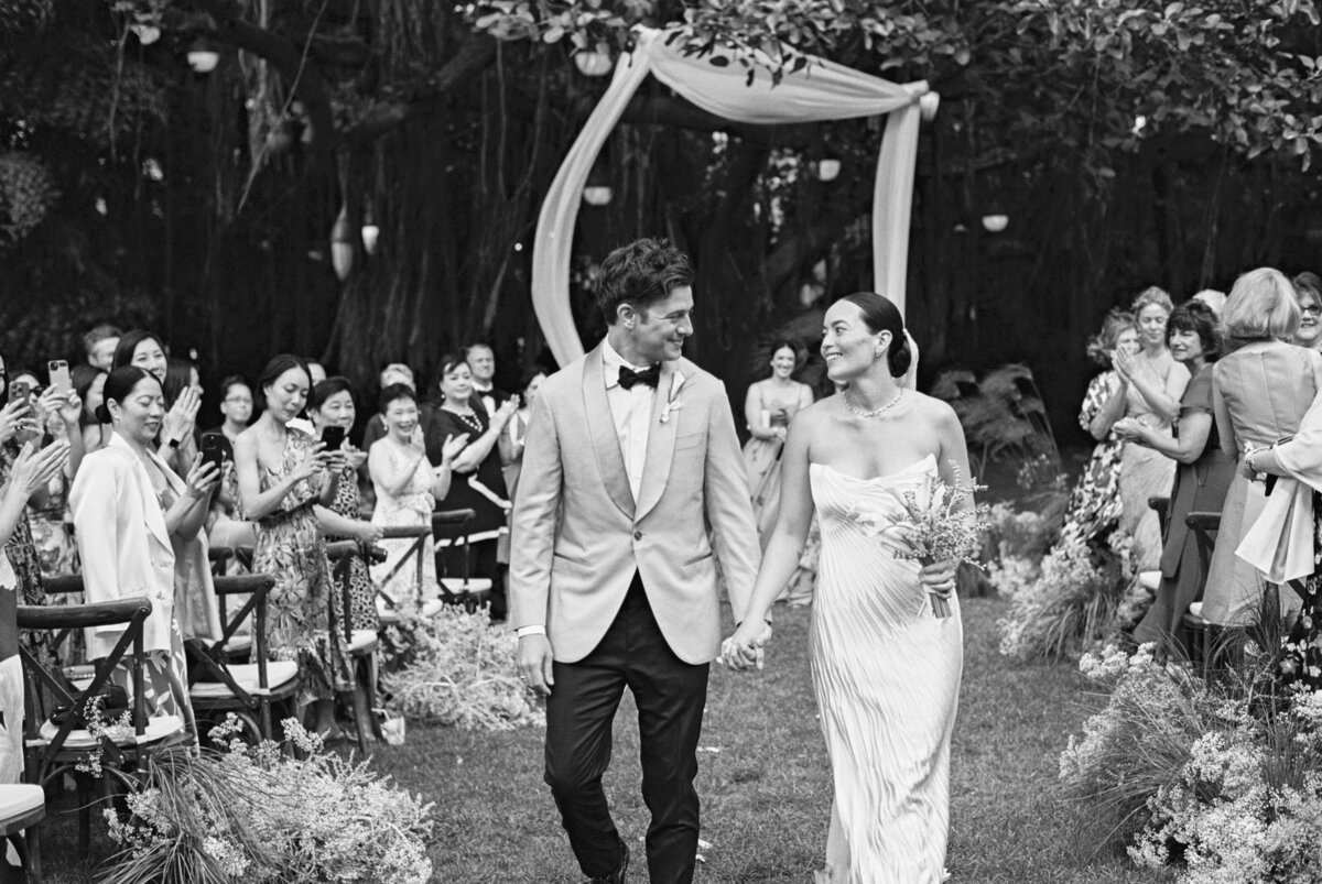 wedding and elopement photographer, black and white image of couple walking back down the aisle after ceremony