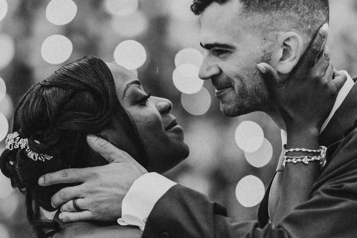 black and white image of wedding couple about to kiss