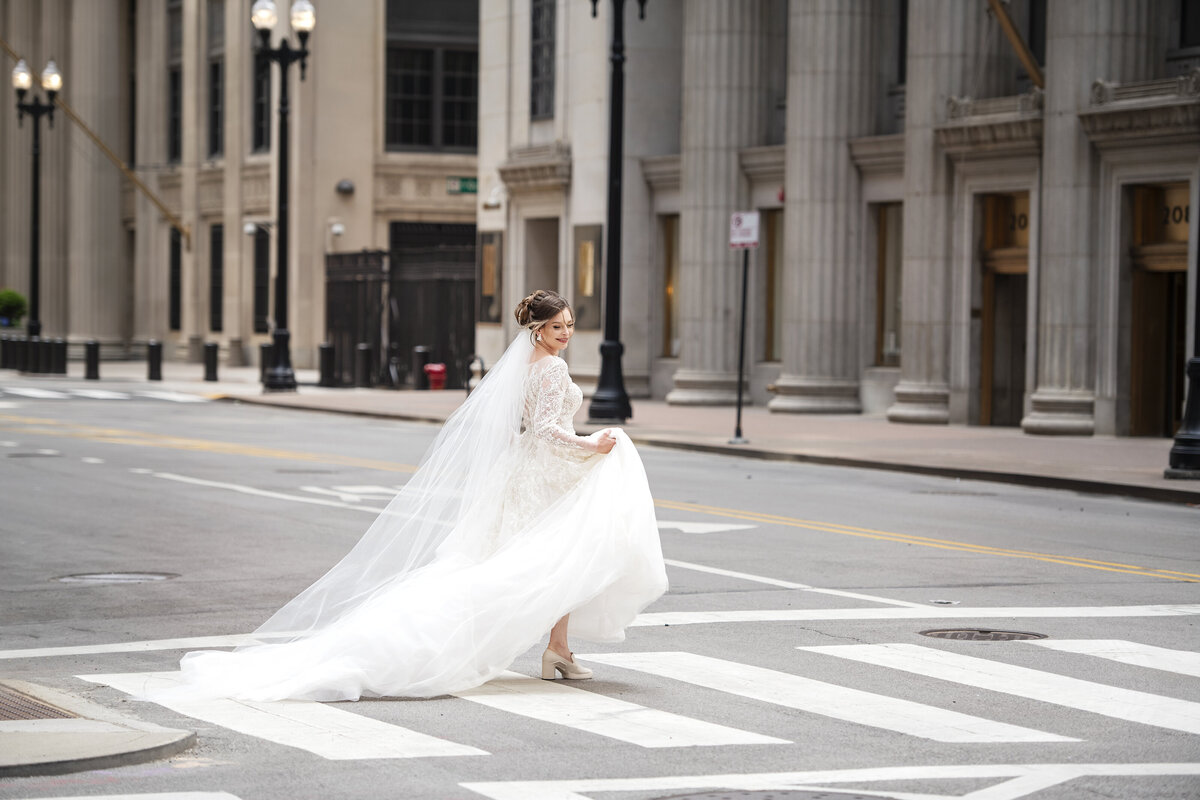 Bride crossing the street by Chicago board of trade building