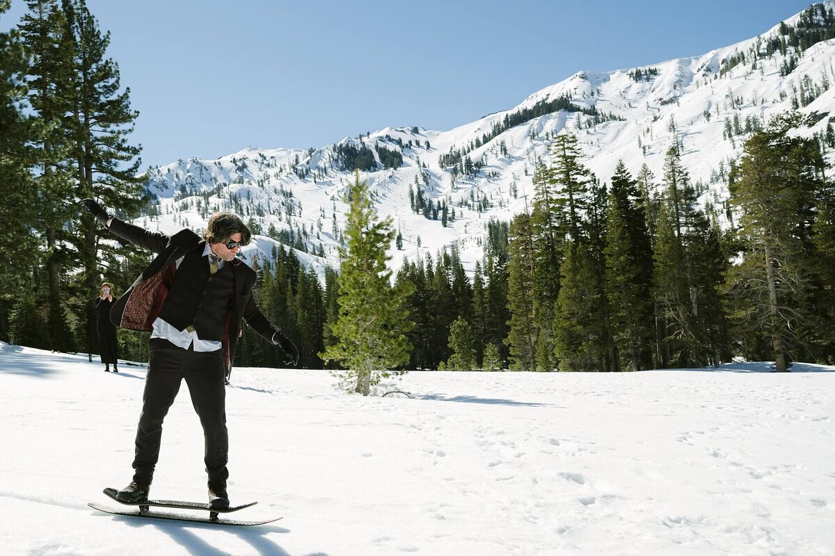 groom on snowskate in winter elopement  in Tahoe