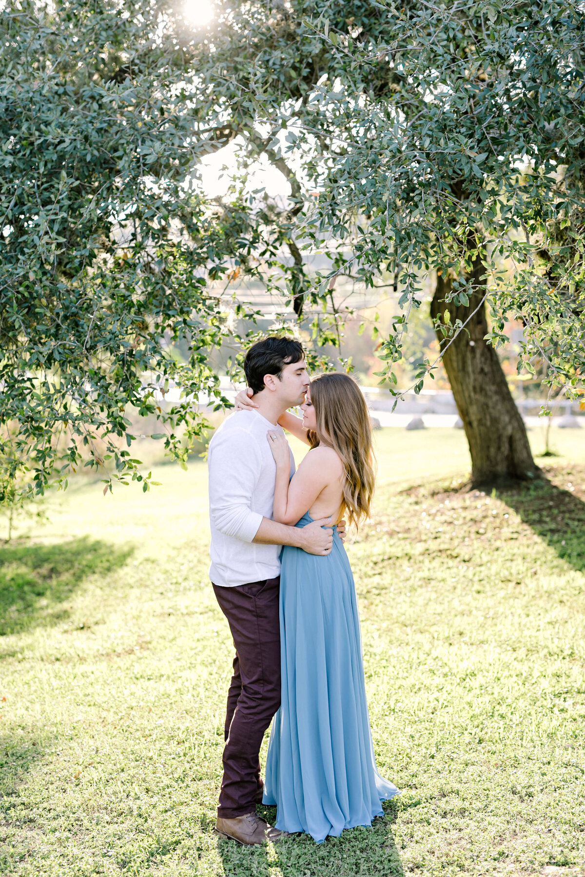 Couple holding hands and embracing at their Austin engagement session