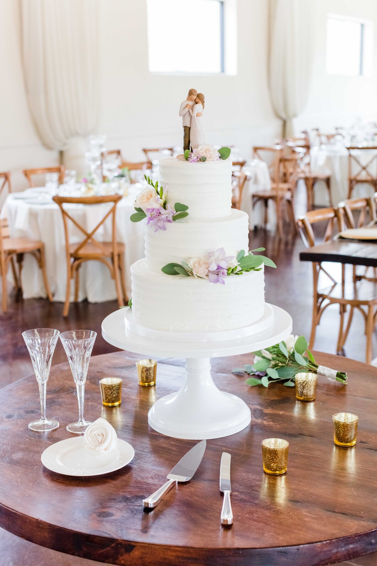 3 tier wedding cake with lavender flowers and crystal champagne flutes by Firefly Photography