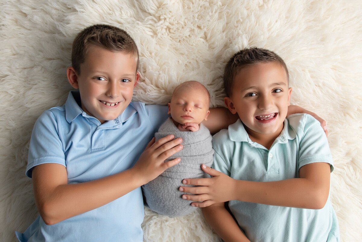 brothers with newborn baby