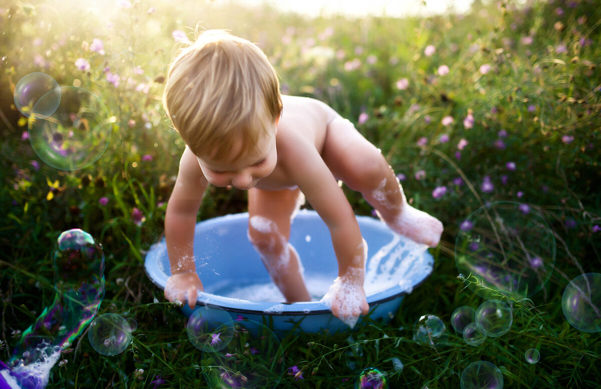 Baby climbs out of an antique washtub during Family Photoshoot in Asheville, NC.