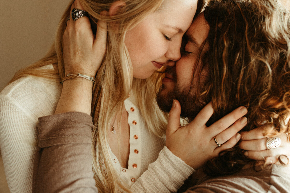 A couple is holding each other closely and kissing.