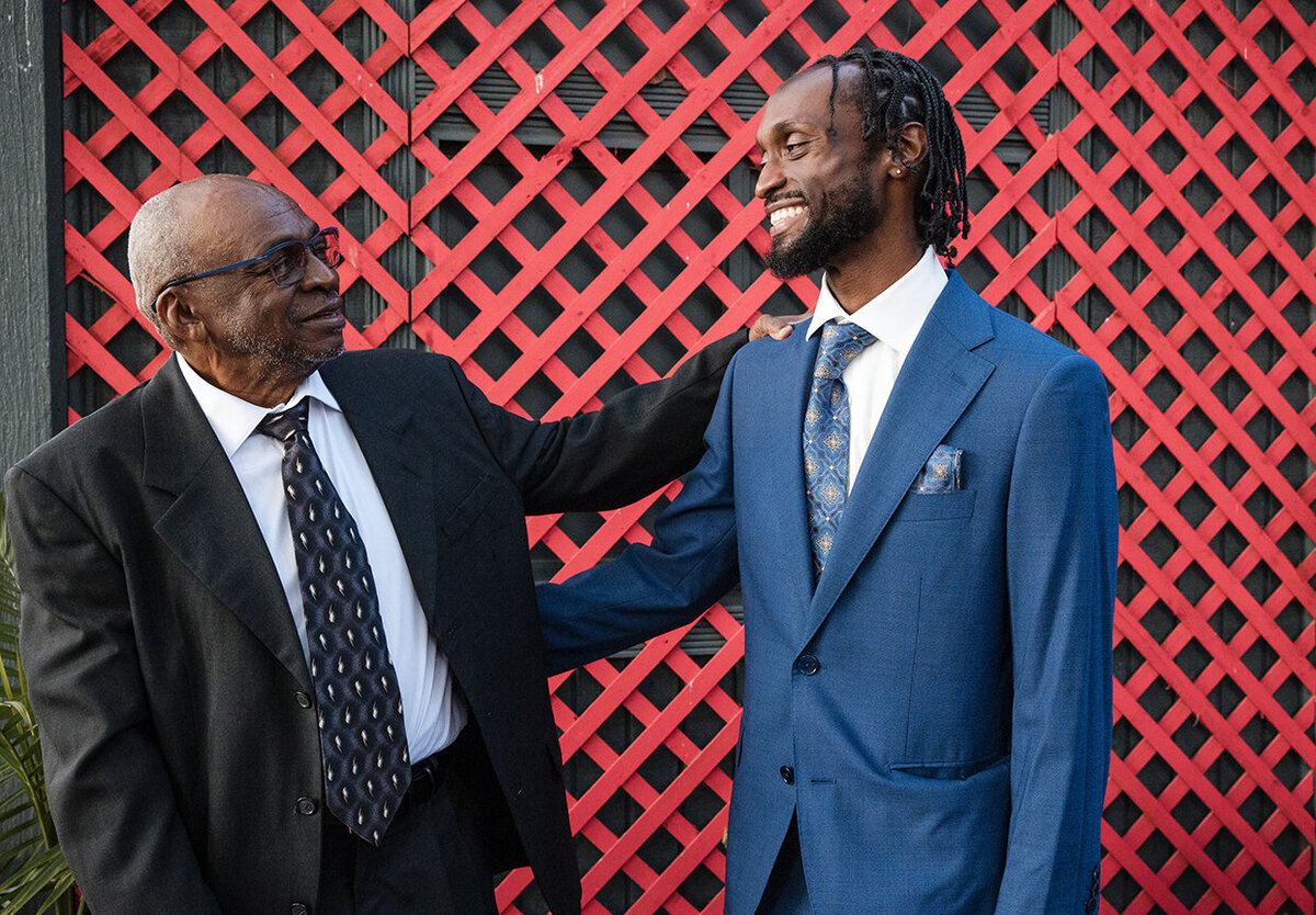African-American groom being congratulated by his elderly father.