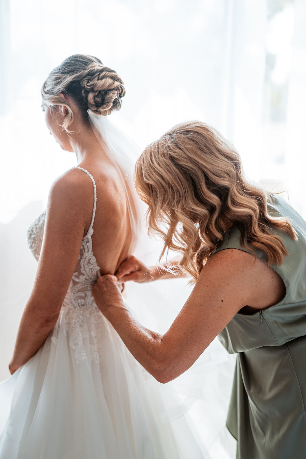 Emily getting her wedding dress perfectly ready for her wedding ceremony