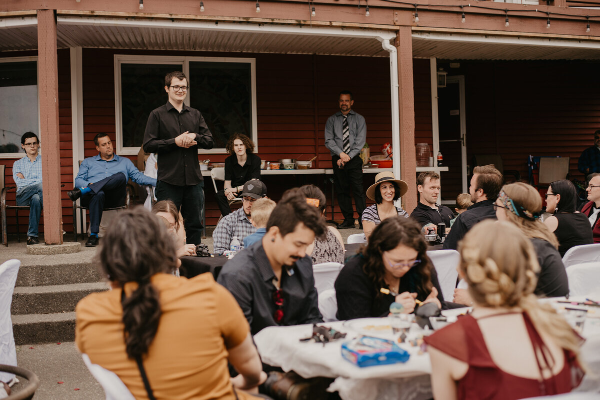 Toast being given by the brother of the groom while everyone looks at him.