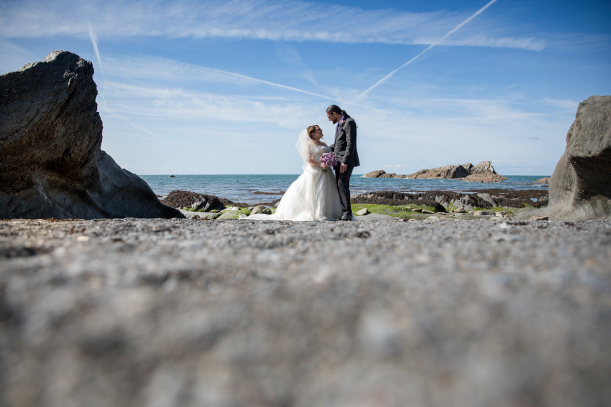 Low level wedding photo on beach at Tunnels Beaches Devon