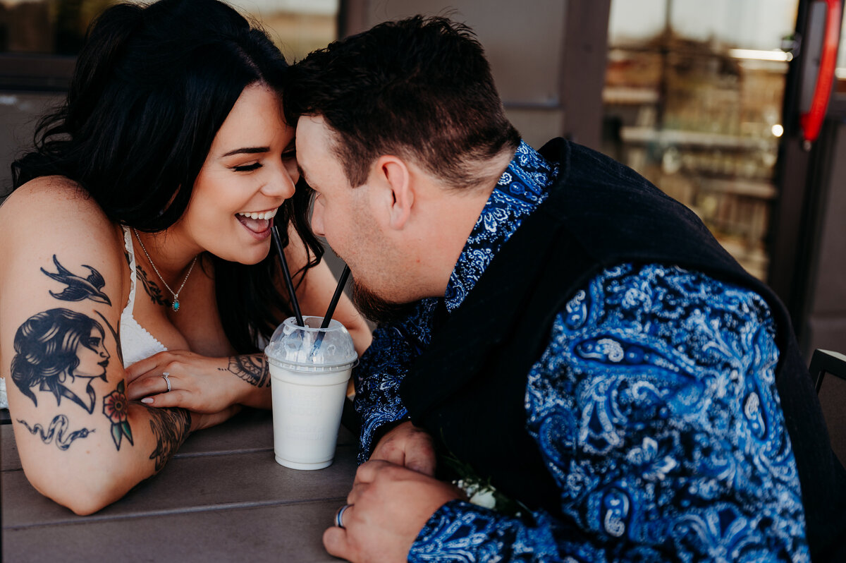 bride and groom sharing a milkshare