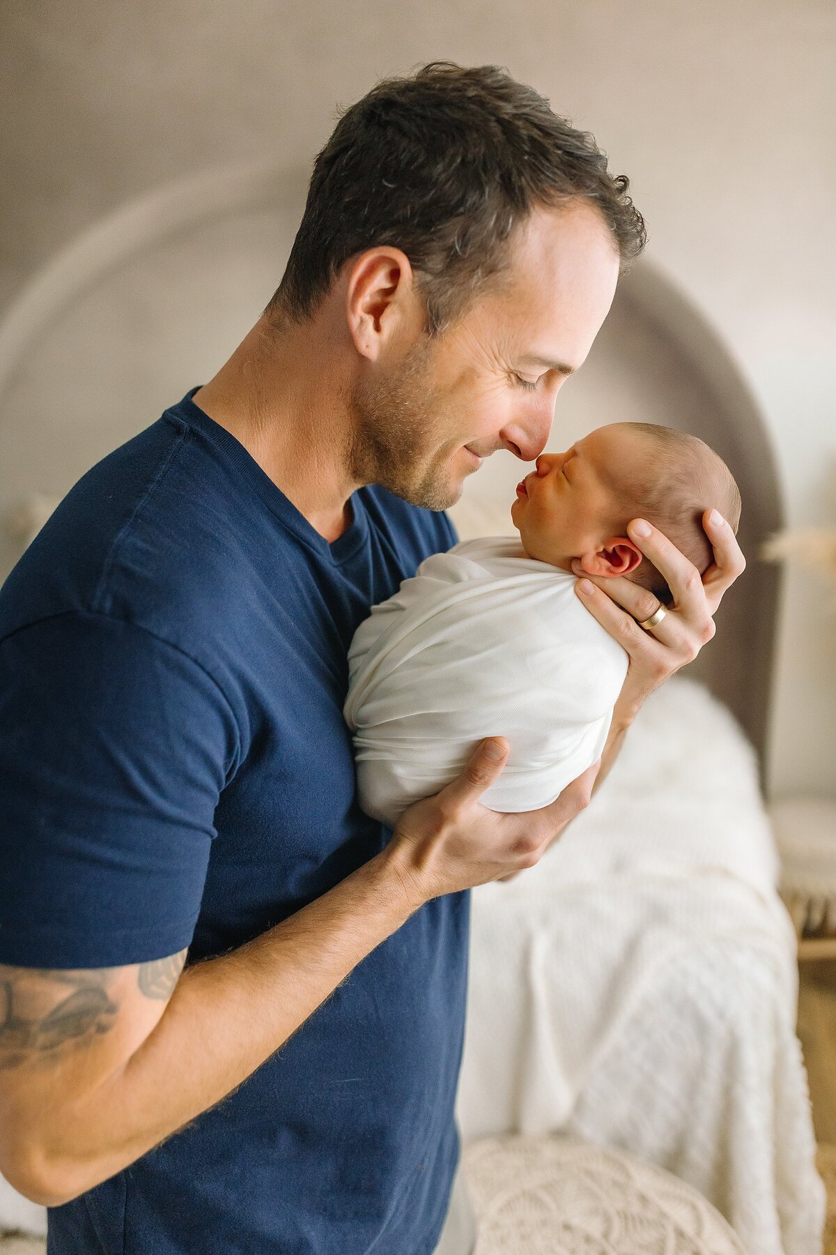 Dad holding newborn son in Harrisonburg VA newborn studio