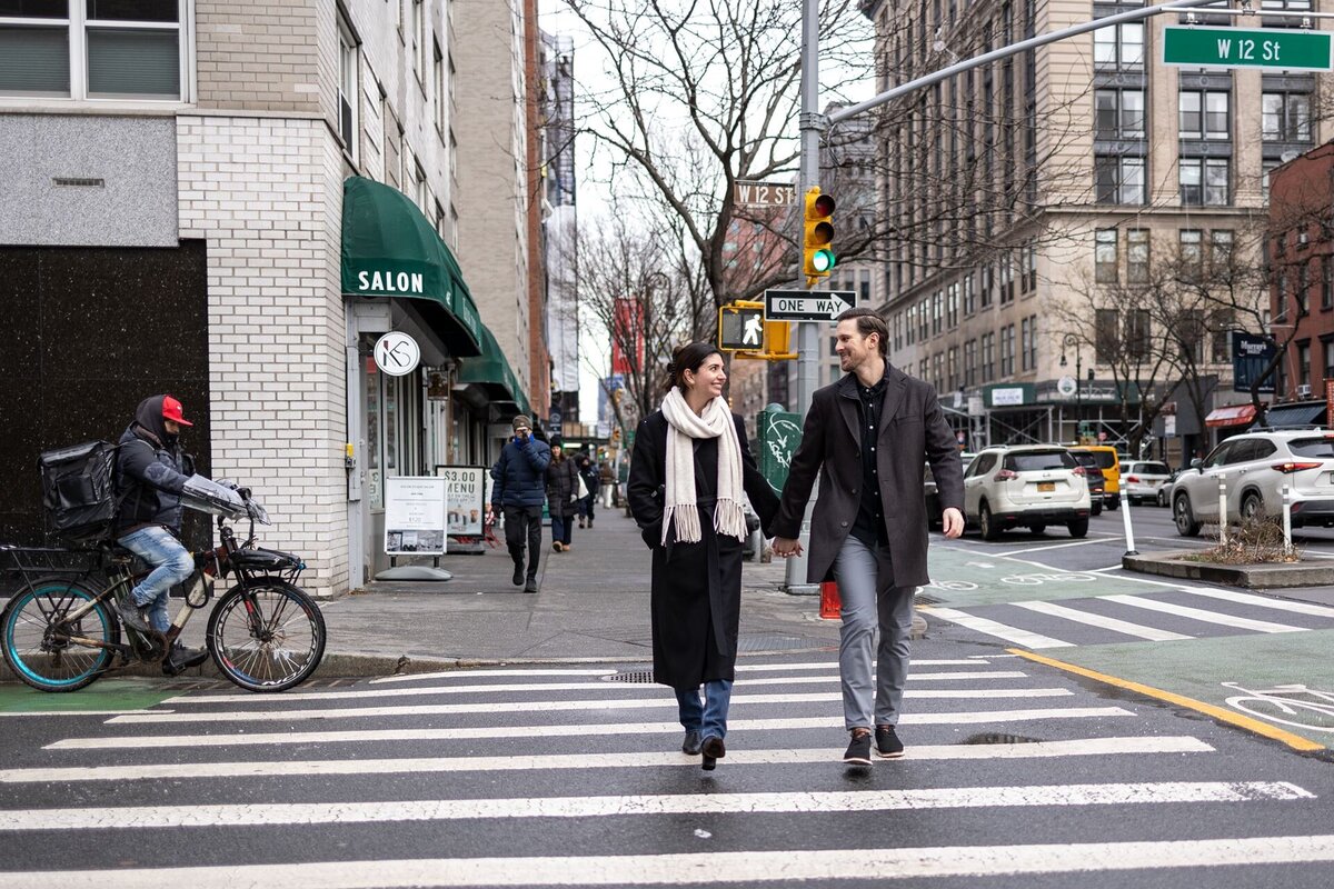 Attractive engagement photo session of couple walking through the crosswalks of Greenwhich Villiage.