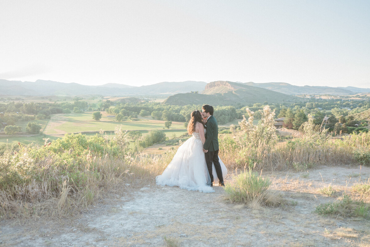 A newly married couple kiss near Denver, Colorado after their Colorado wedding.