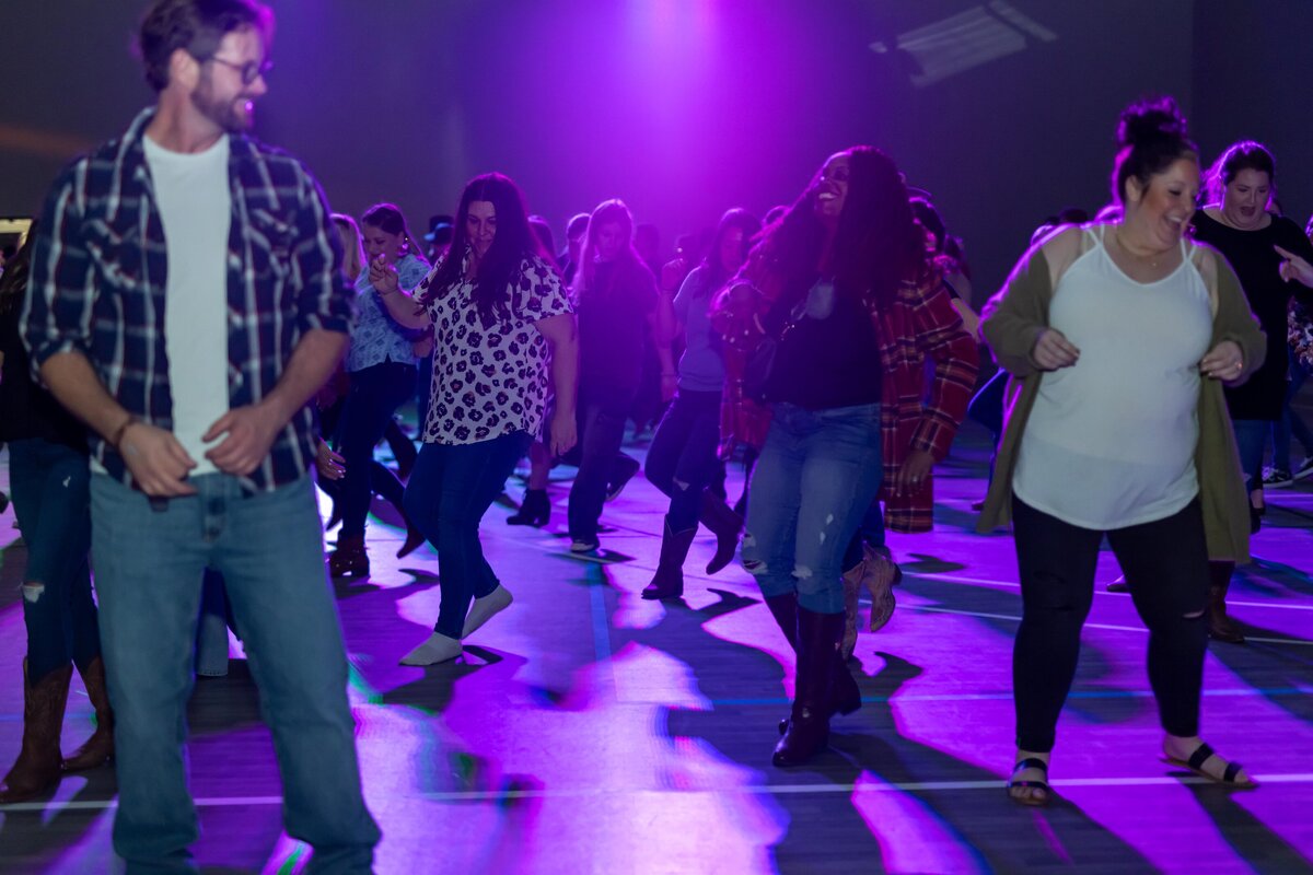 group of people practicing line dancing