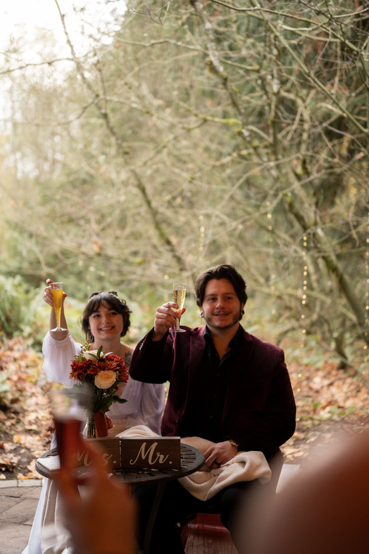 Bride and groom cheers glasses taken by wedding photographers in Idaho.
