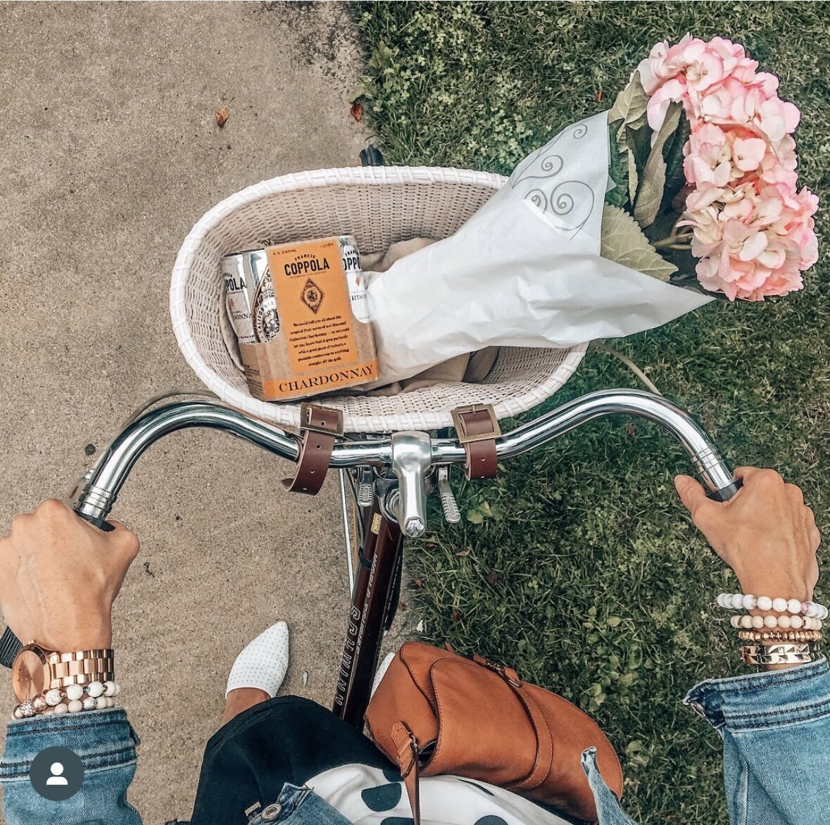 Photo of bike and basket with coppola cans and flowers by AMALYN @amalynsocial and @amalynstyle