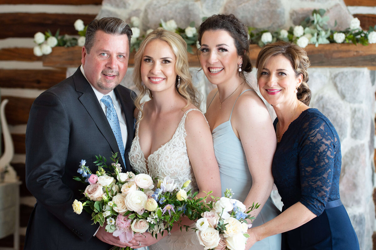 a Bride smiling happily with her family during Ottawa wedding family photos