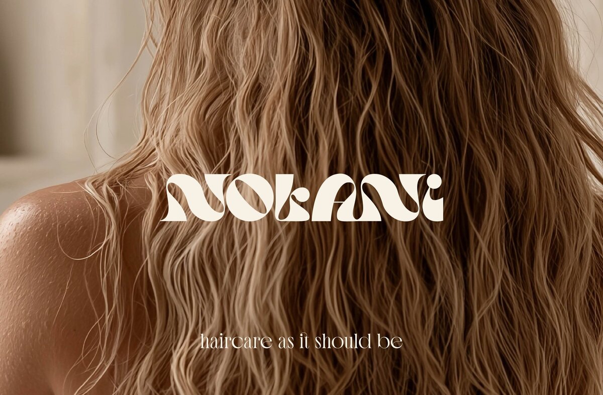 back of woman with blonde wavy hair-nolani logo