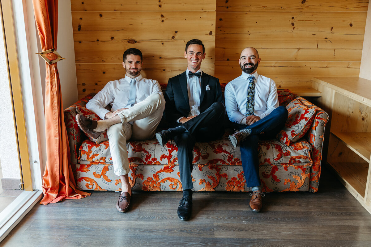 Groom and groomsmen getting ready in hotel room