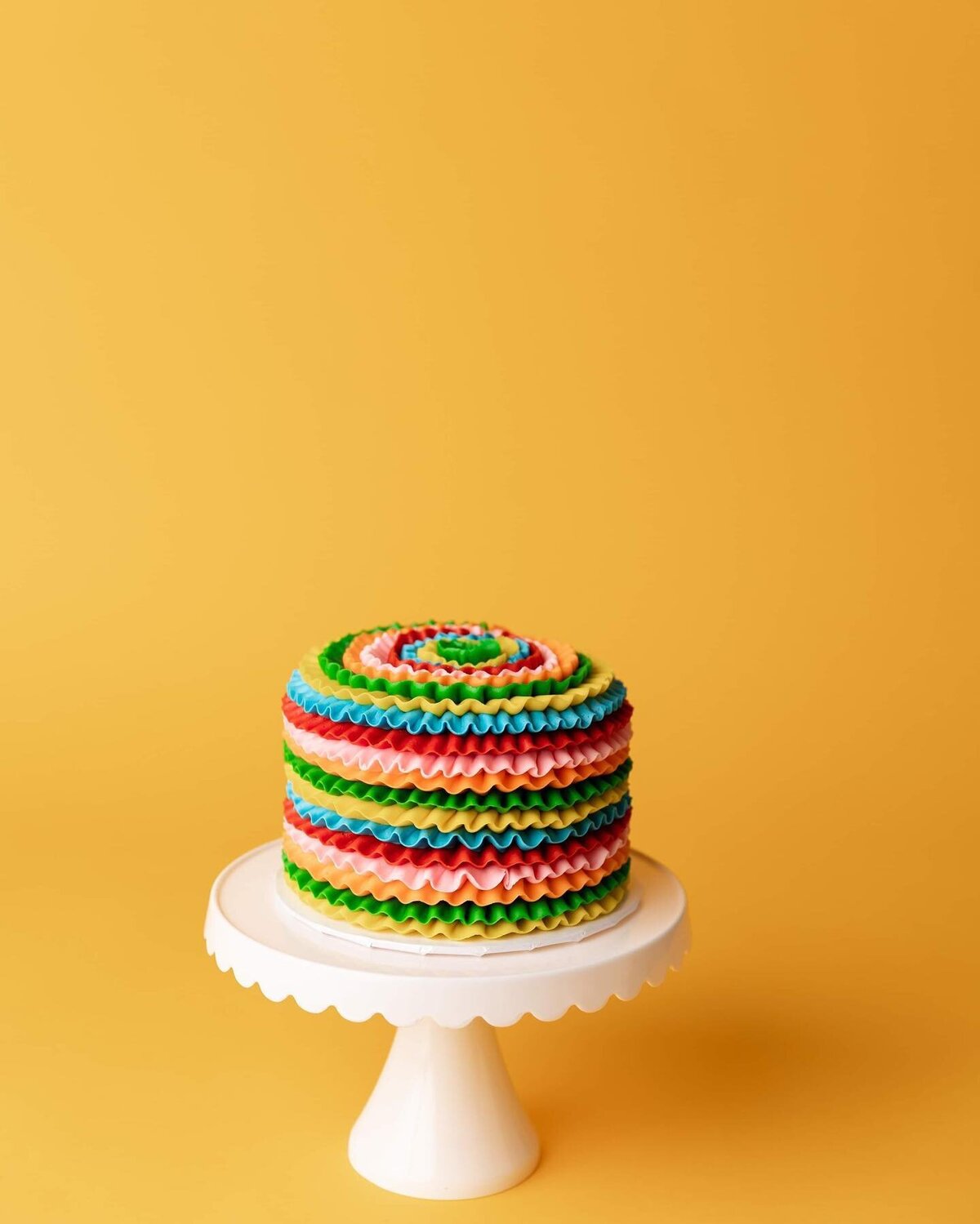 colorful cake on yellow backdrop